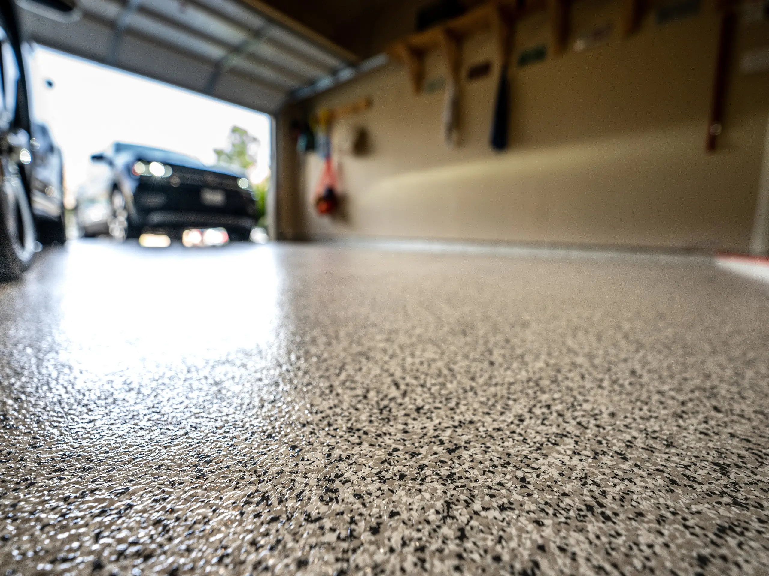 Speckled epoxy garage floor with parked car